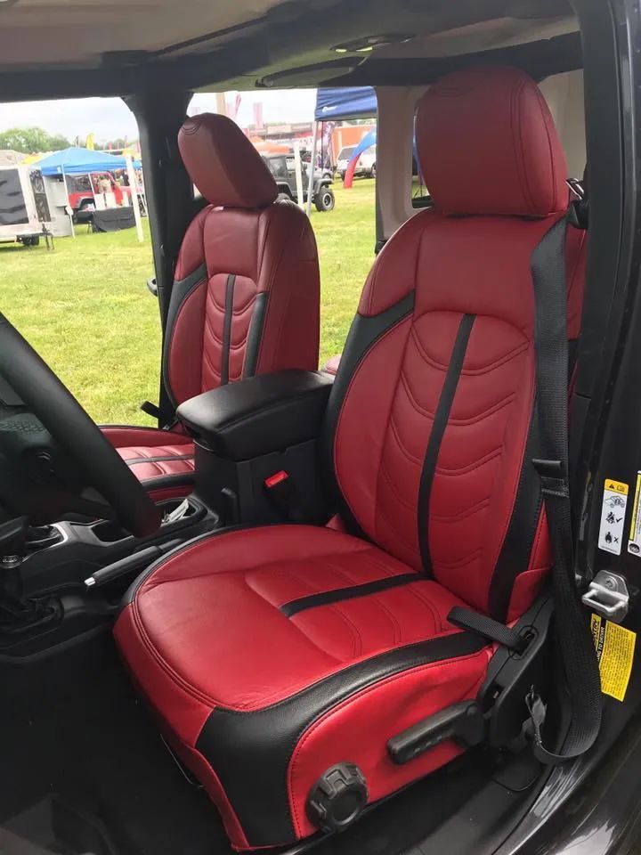 The front seats of a jeep wrangler are red and black