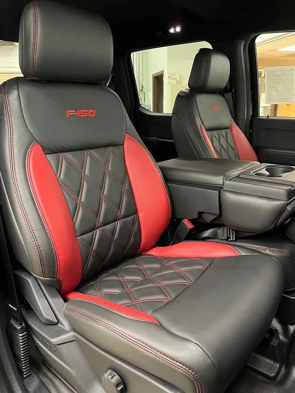 The front seats of a ford f150 truck are black and red