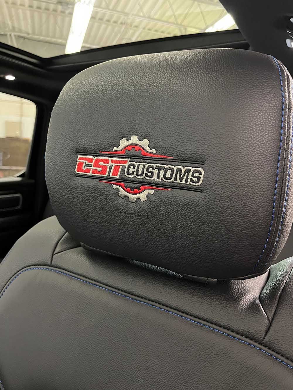 A close up of a headrest in a car with a logo on it