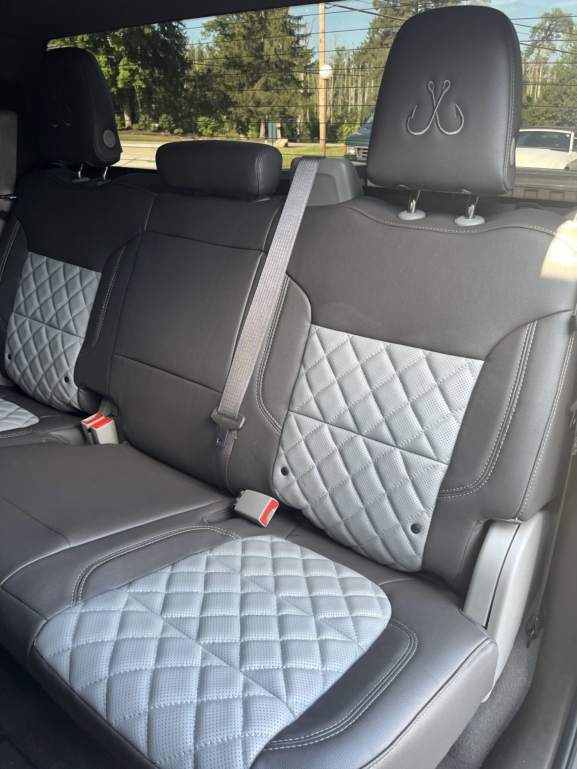 The back seat of a car with a seat belt on it