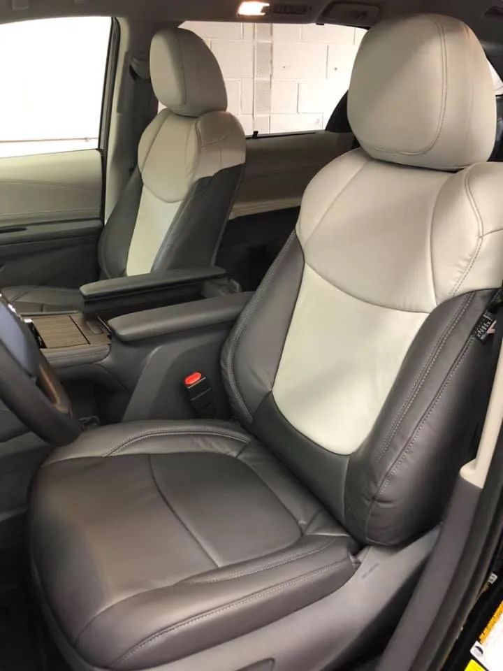 The front seats of a toyota sienna are black and white