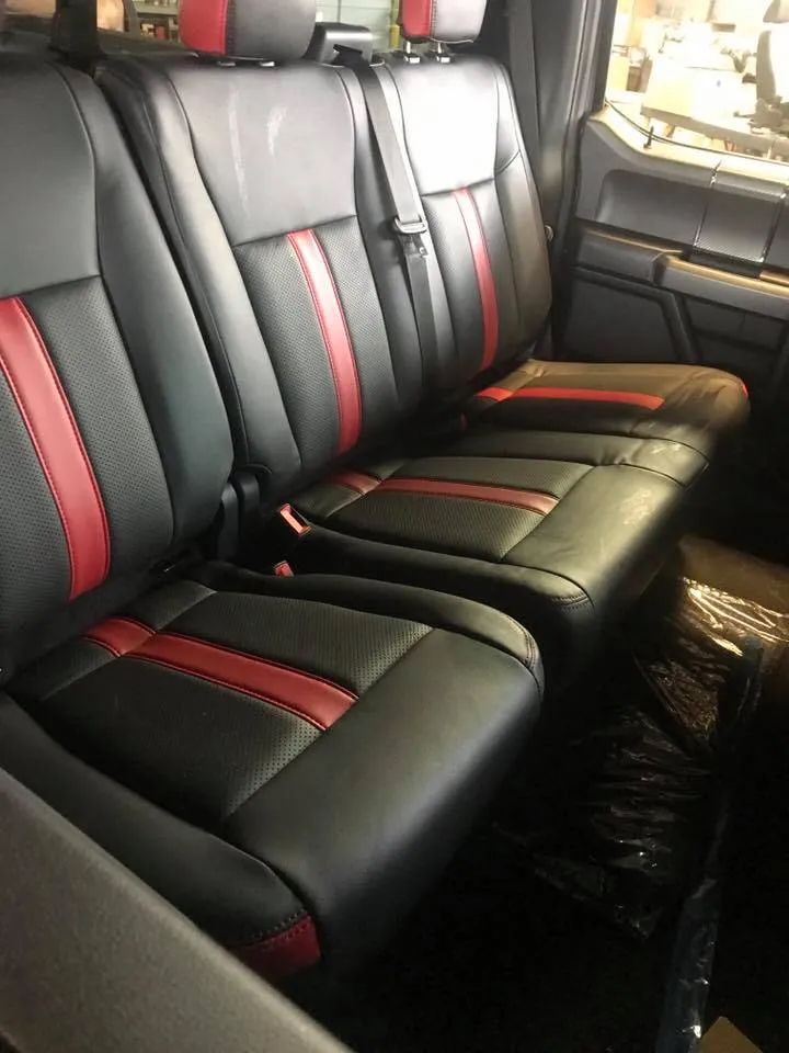 The back seats of a truck are black and red