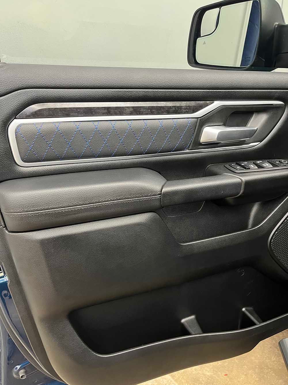 A close up of a car door with a rear view mirror