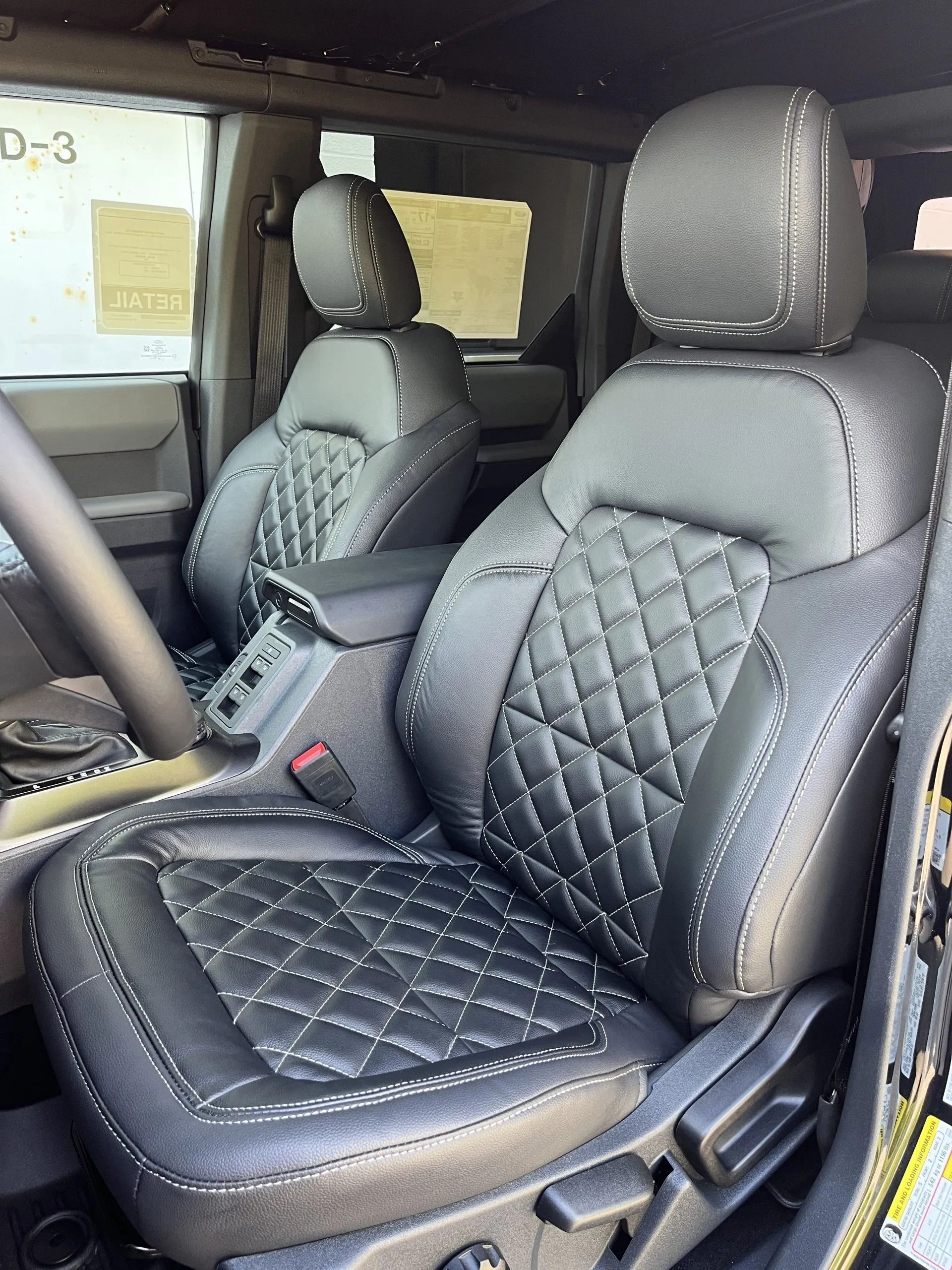 The front seats of a ford bronco are quilted leather