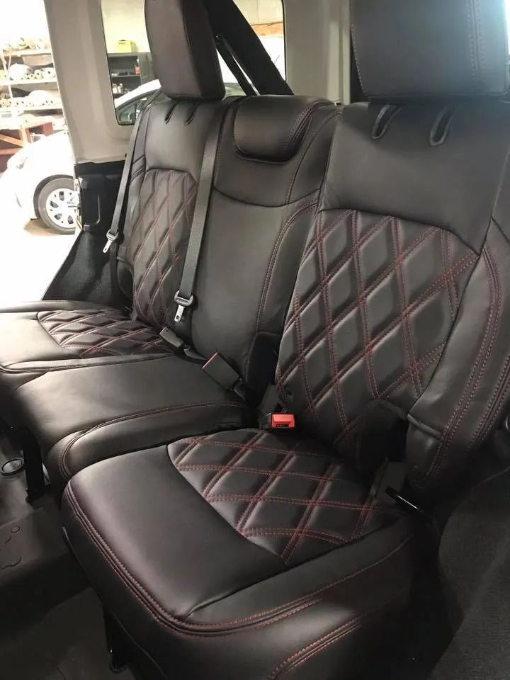 The back seats of a jeep wrangler are black and red