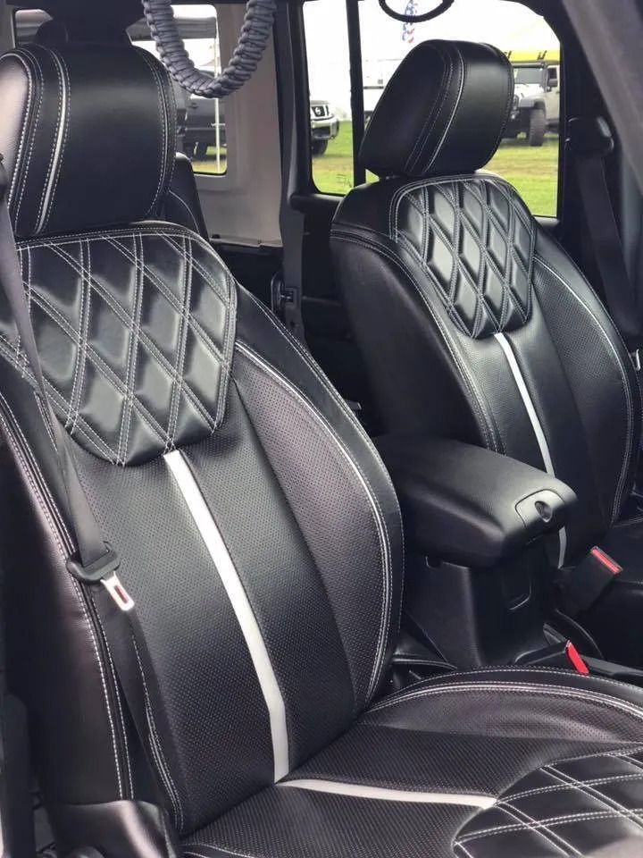 The front seats of a jeep are black and white