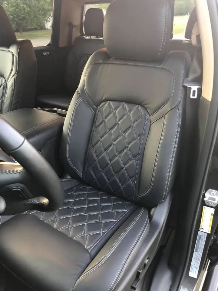 A close up of a car seat with a steering wheel