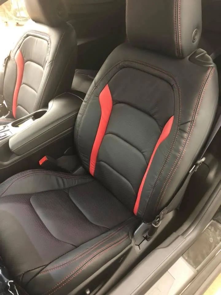 A black car with red stripes on the seats