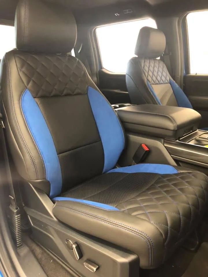The seats of a truck are black and blue