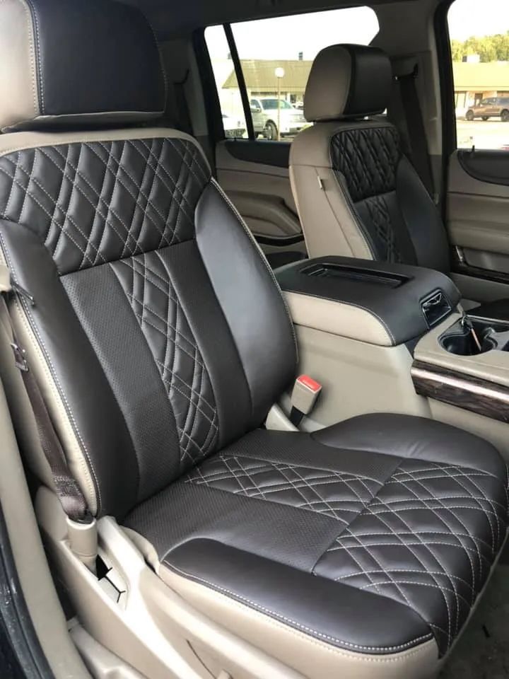 The interior of a car with black and tan leather seats
