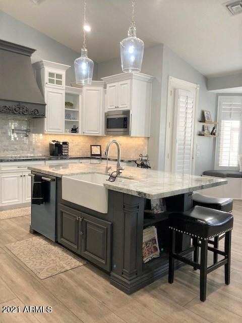 A kitchen with a large island and a sink