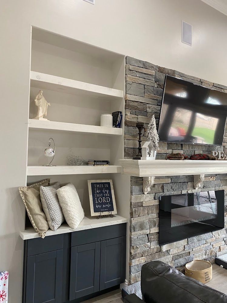 A living room with a fireplace and a flat screen tv.