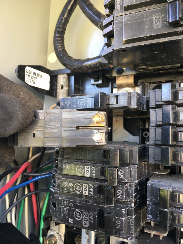 A close up of a electrical box with a lot of wires coming out of it.