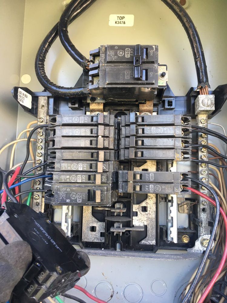 A close up of a electrical box with wires coming out of it.