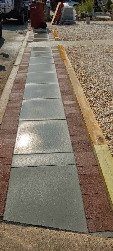 A walkway made of bricks and tiles is being built.