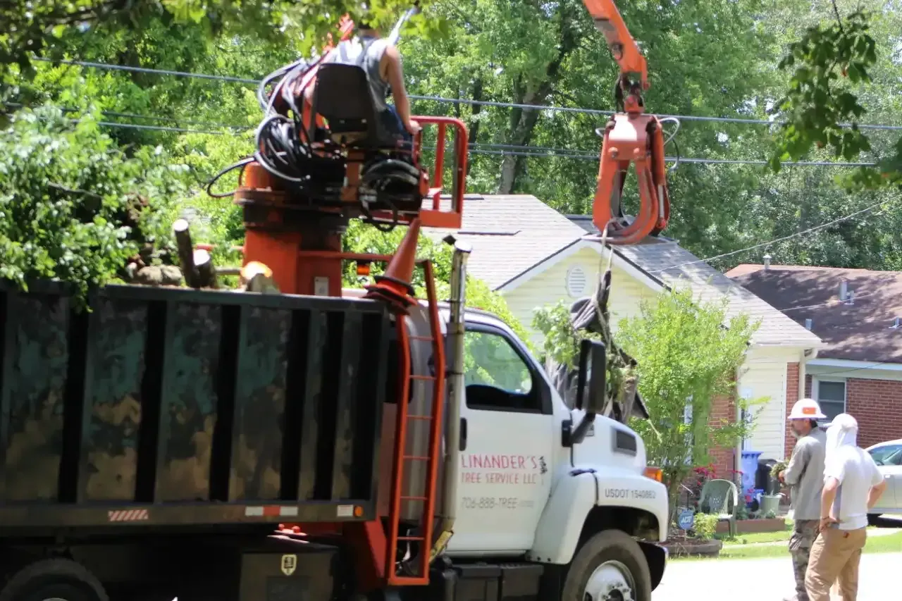 A dump truck with a crane on the back of it