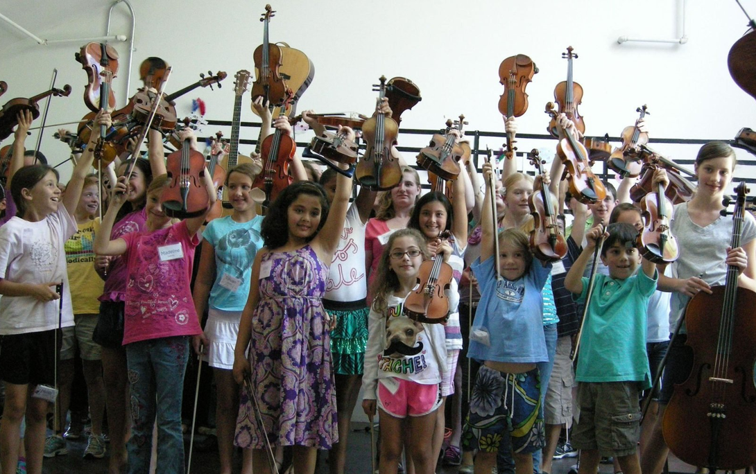 picture of kids holding up a violin