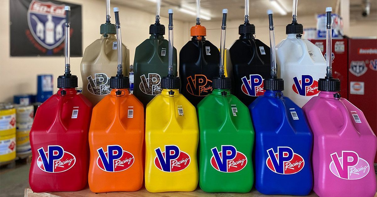 Row of various colored VP Racing fuel jugs.