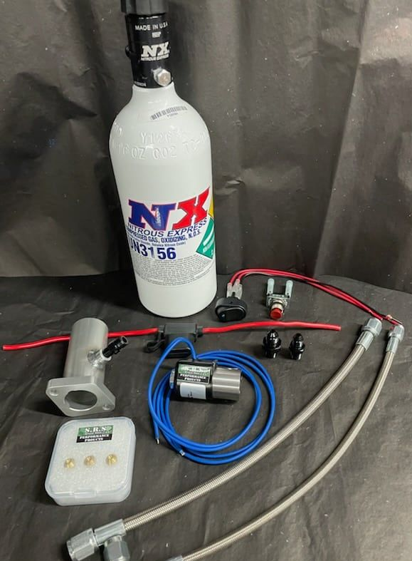 Nitrous oxide system parts laid out: bottle, lines, solenoids, control unit.