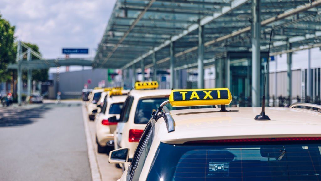 A row of taxi waiting outside the airport.