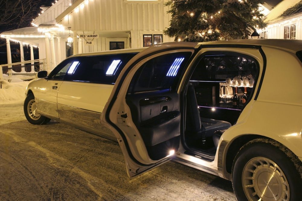 Bottles of bubbly visible inside the limo. Restaurant and Pub signs visible in the background.