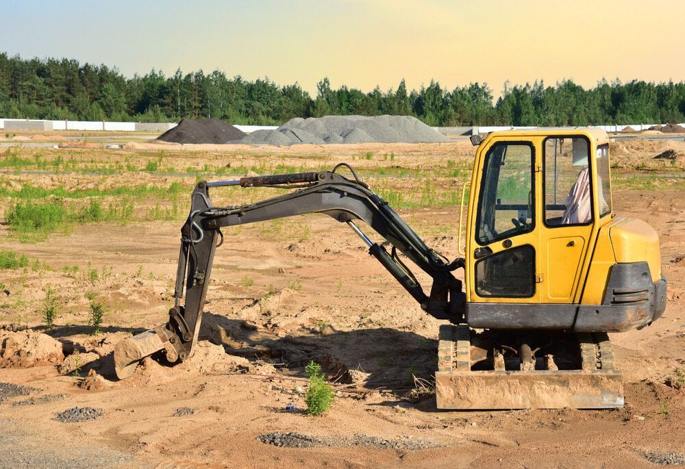 Yellow excavator on dirt at construction site.— Mini Digger and Trailer Hire in Atherton, QLD