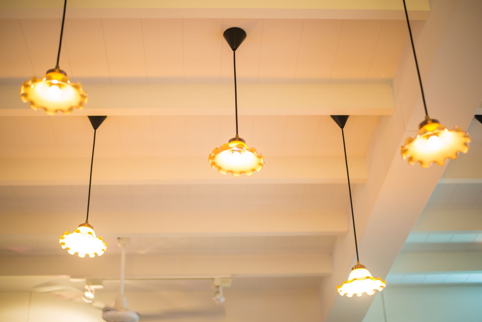 A ceiling adorned with hanging lights from C.M.E. Lighting Supply, perfect for restaurant lighting i