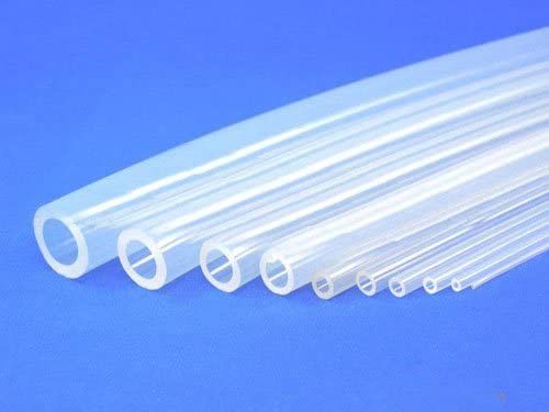 A bunch of clear silicone tubes are lined up on a blue surface.