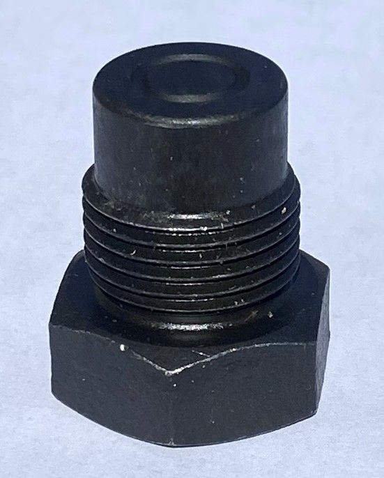 A close up of a black screw on a white surface.