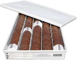 A box filled with four cigars with a white lid.