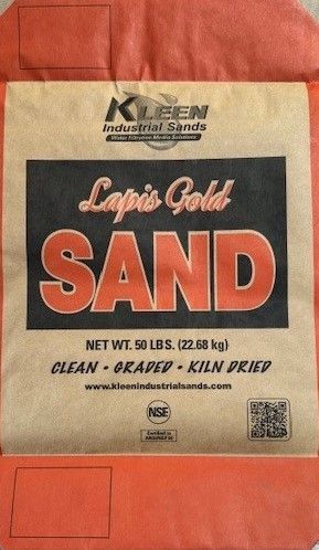 A bag of lapis gold sand is sitting on a table.