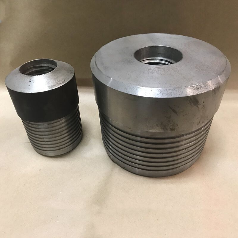 Two pieces of metal are sitting next to each other on a table.