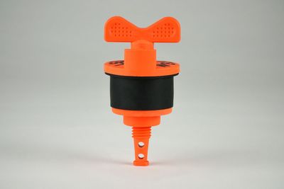 A close up of an orange and black object on a white surface