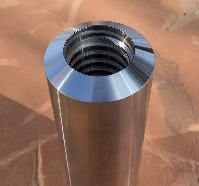 A bunch of metal pieces are lined up on a white surface