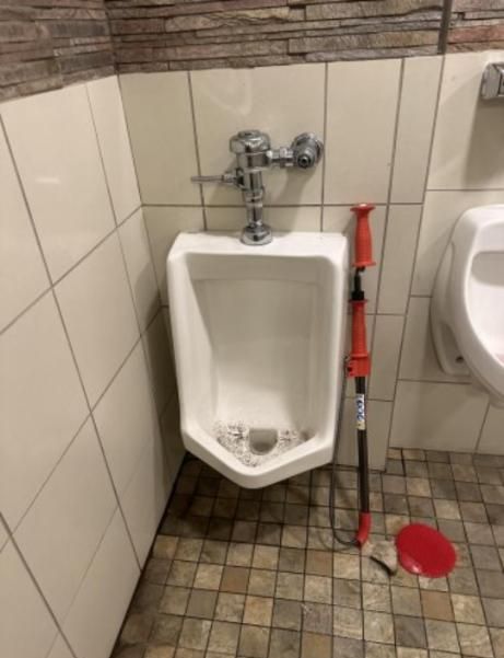 Plumber unclogging toilet with professional force pump cleaner — Delta, CO — On a Budget Rooter
