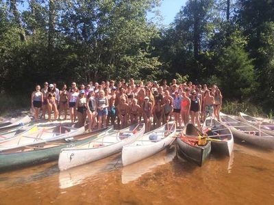 Outdoor Adventure — Group Of People and Canoeing Boats Infront Of Them in Milton, FL