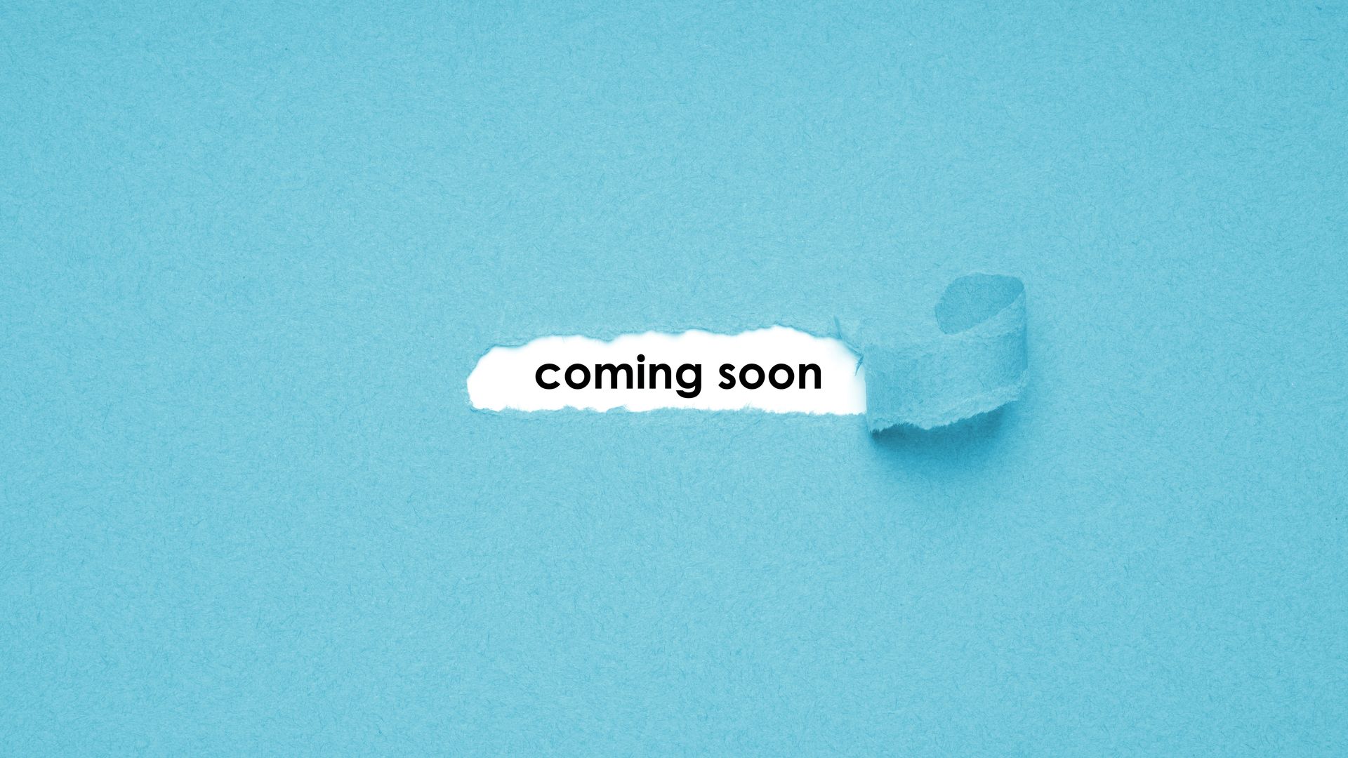 A piece of torn paper with the words `` coming soon '' written on it.