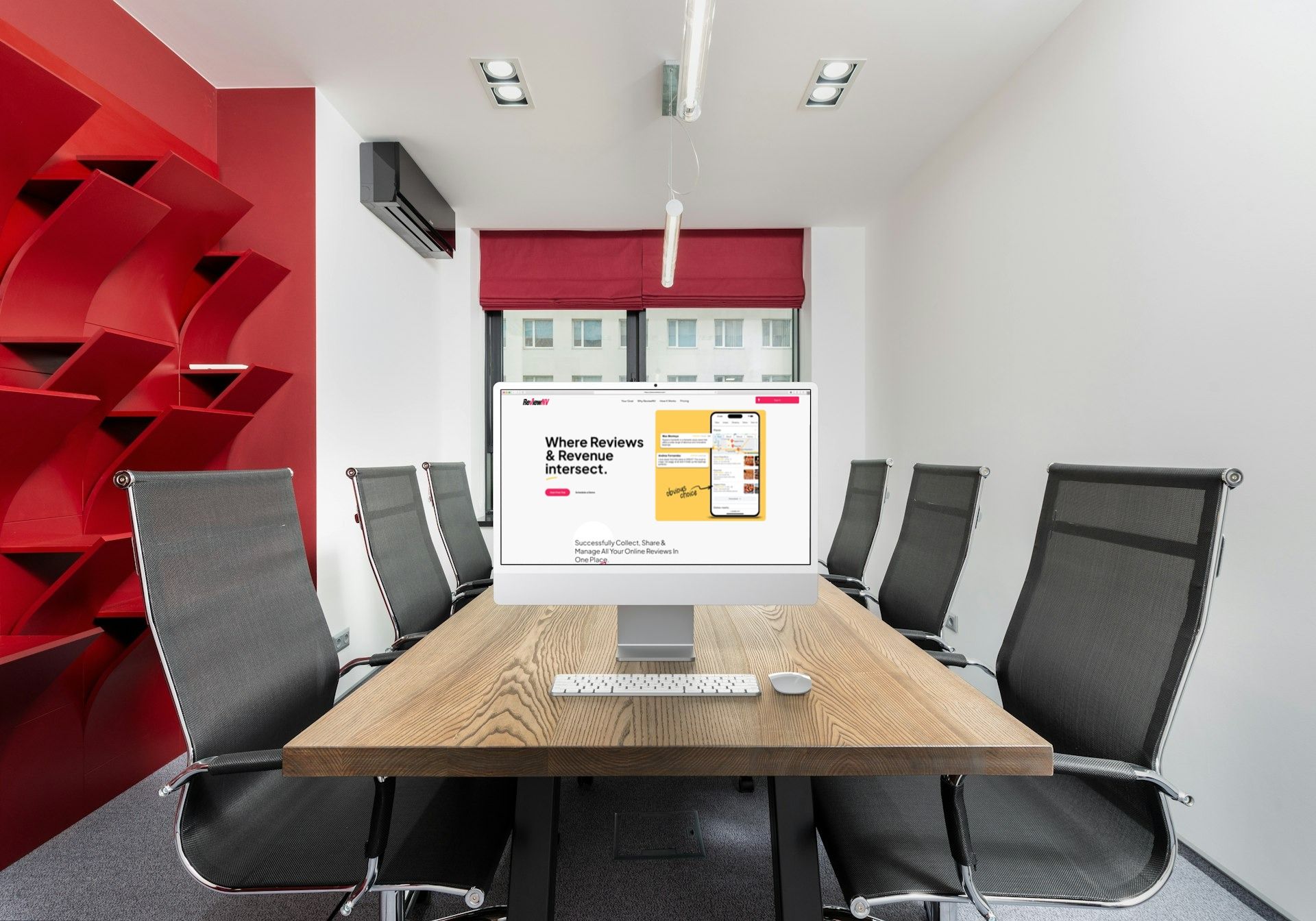 A conference room with a table and chairs and a computer on the table.
