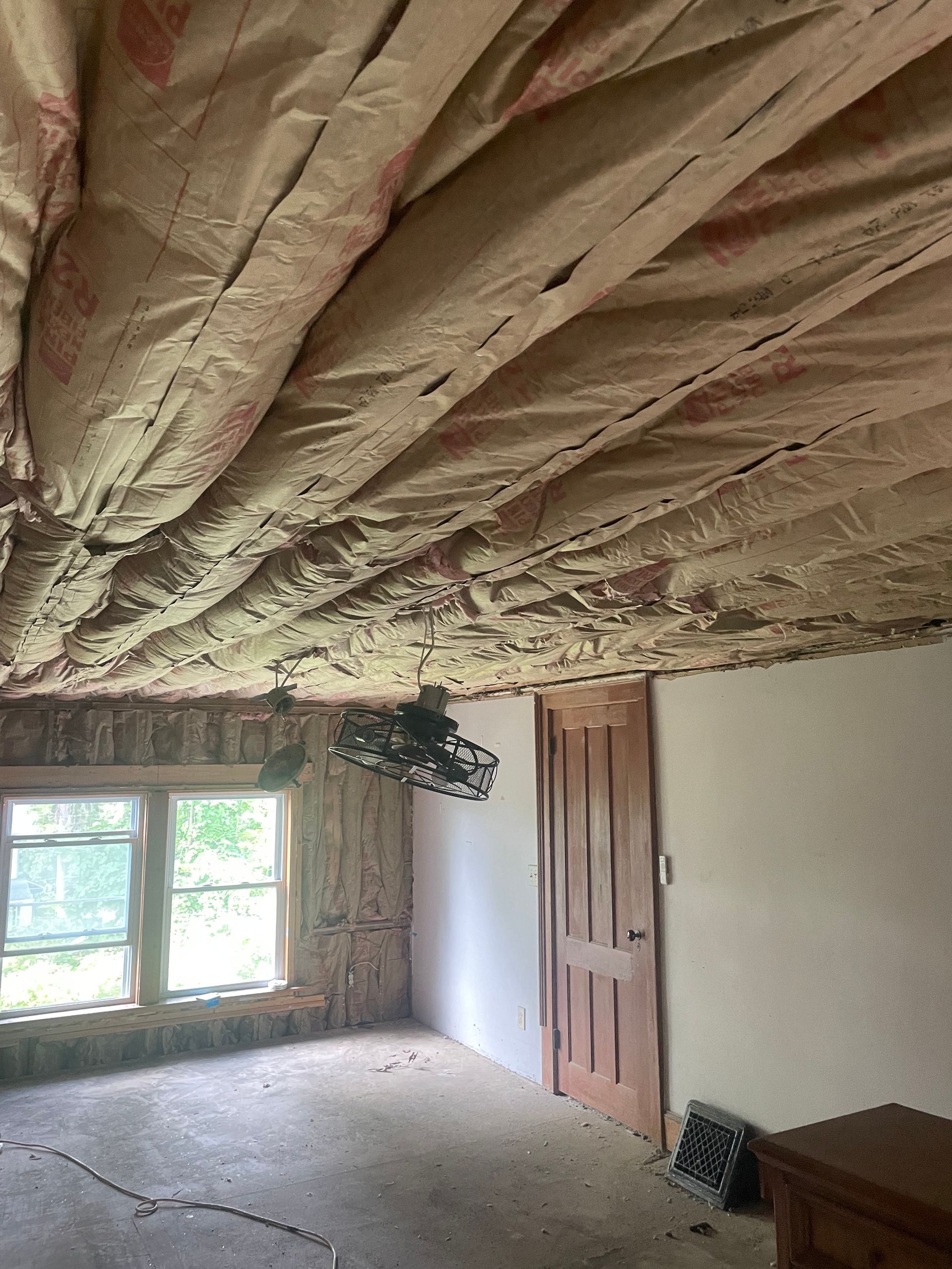 A room with a fan hanging from the ceiling.