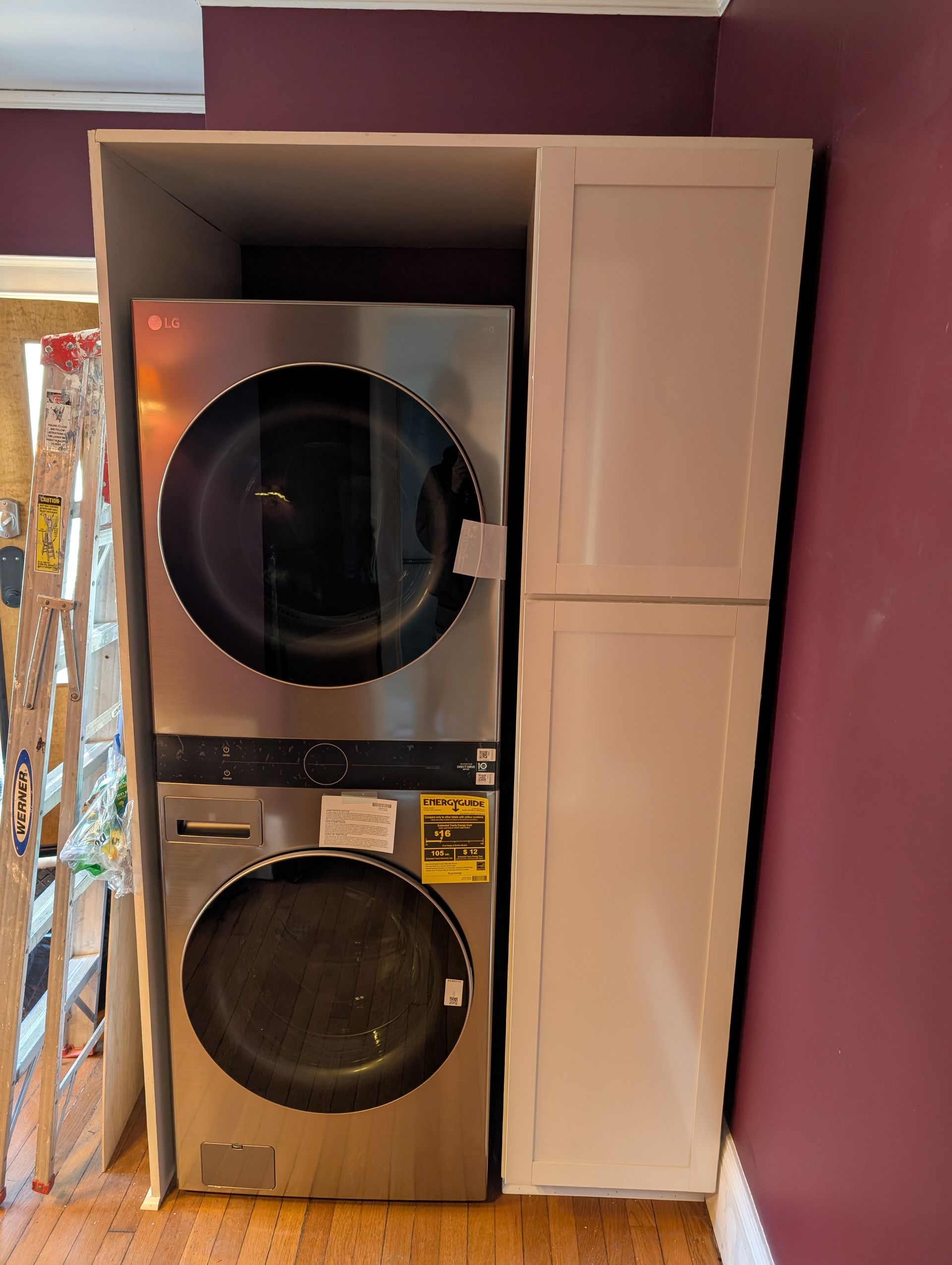 A washer and dryer are stacked on top of each other in a laundry room.