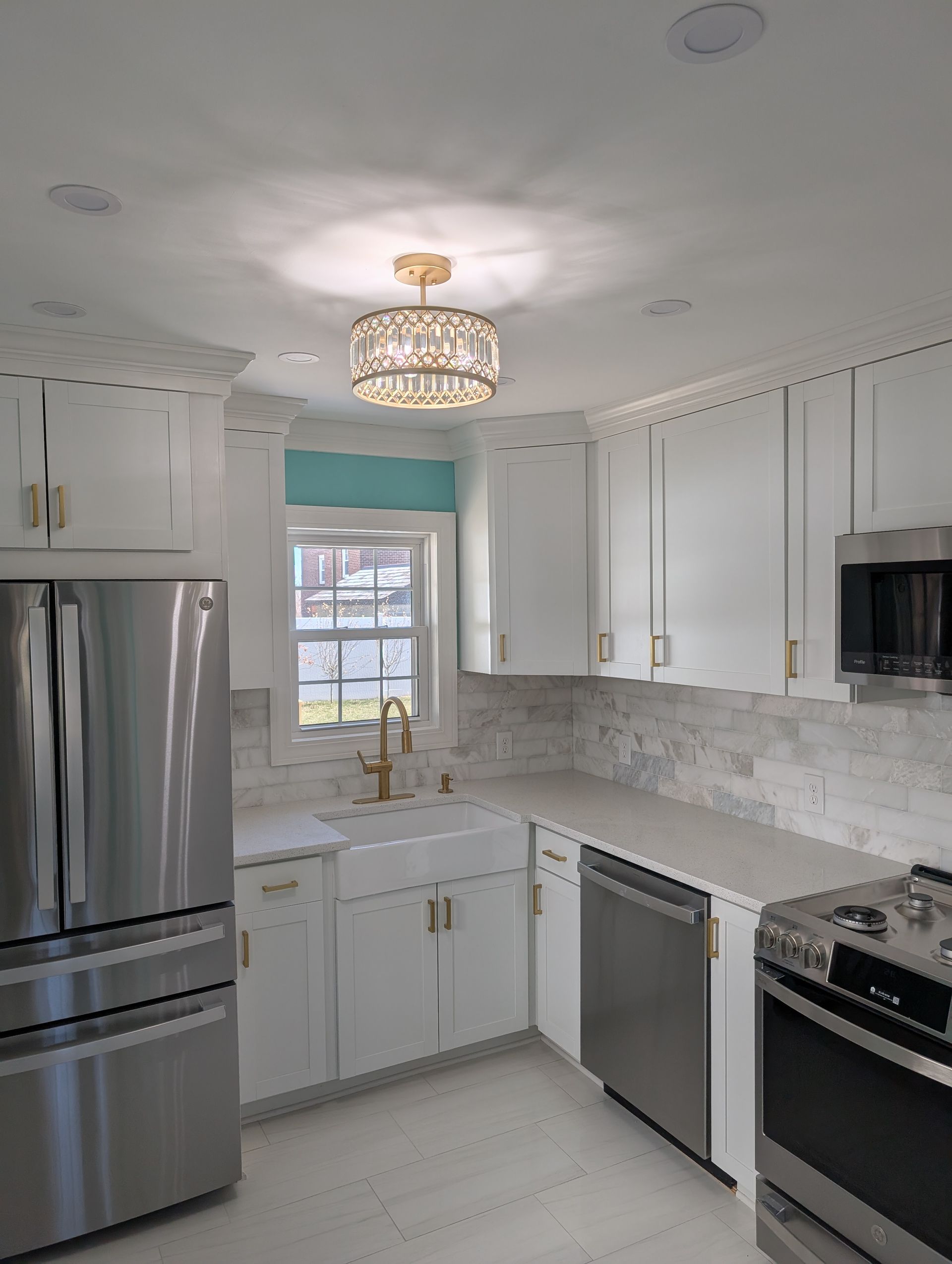 A kitchen with stainless steel appliances and white cabinets