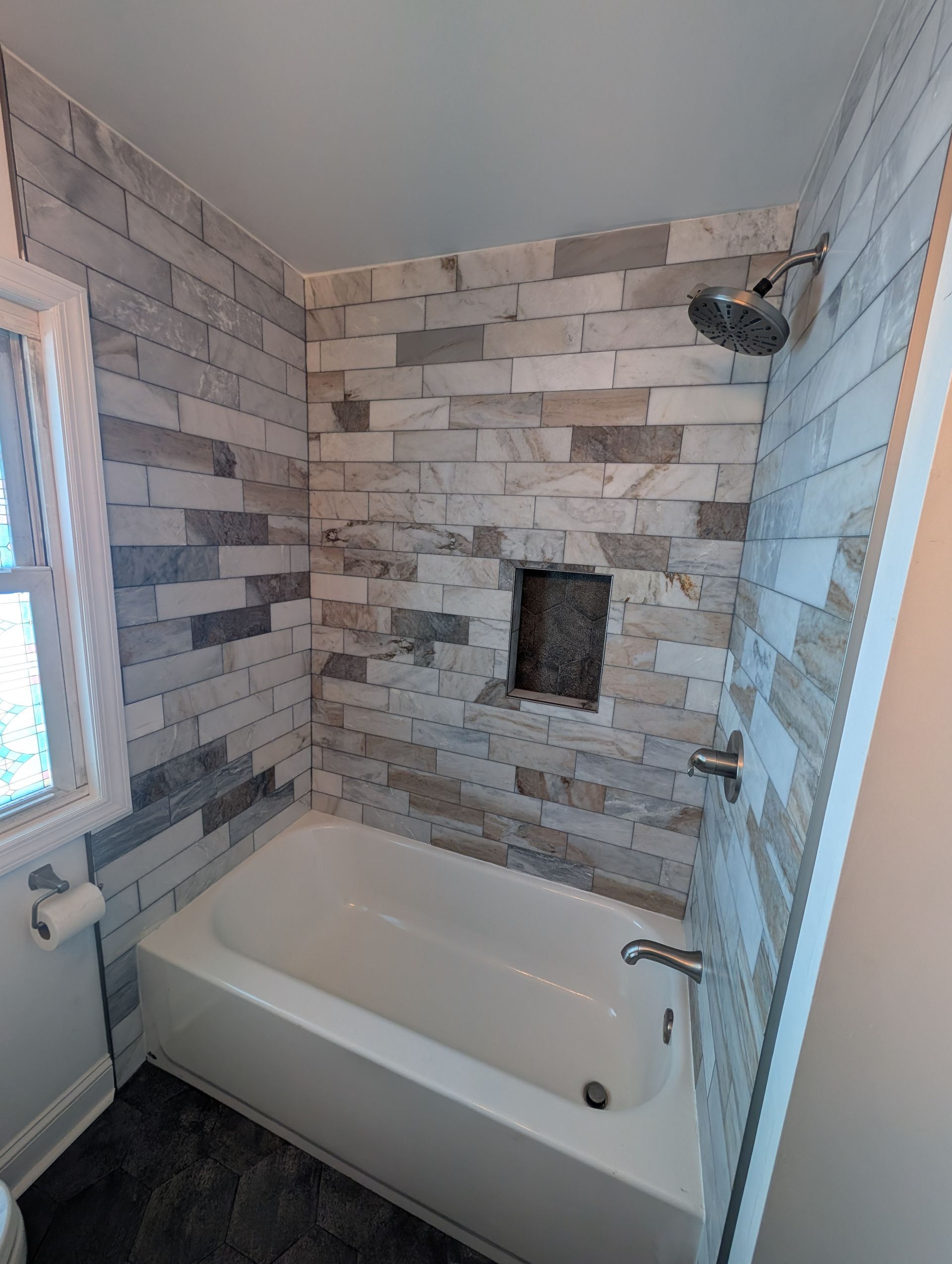 A bathroom with a bathtub and a shower.