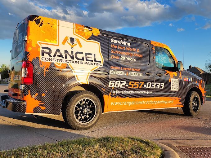 A rangel construction van is parked on the side of the road.