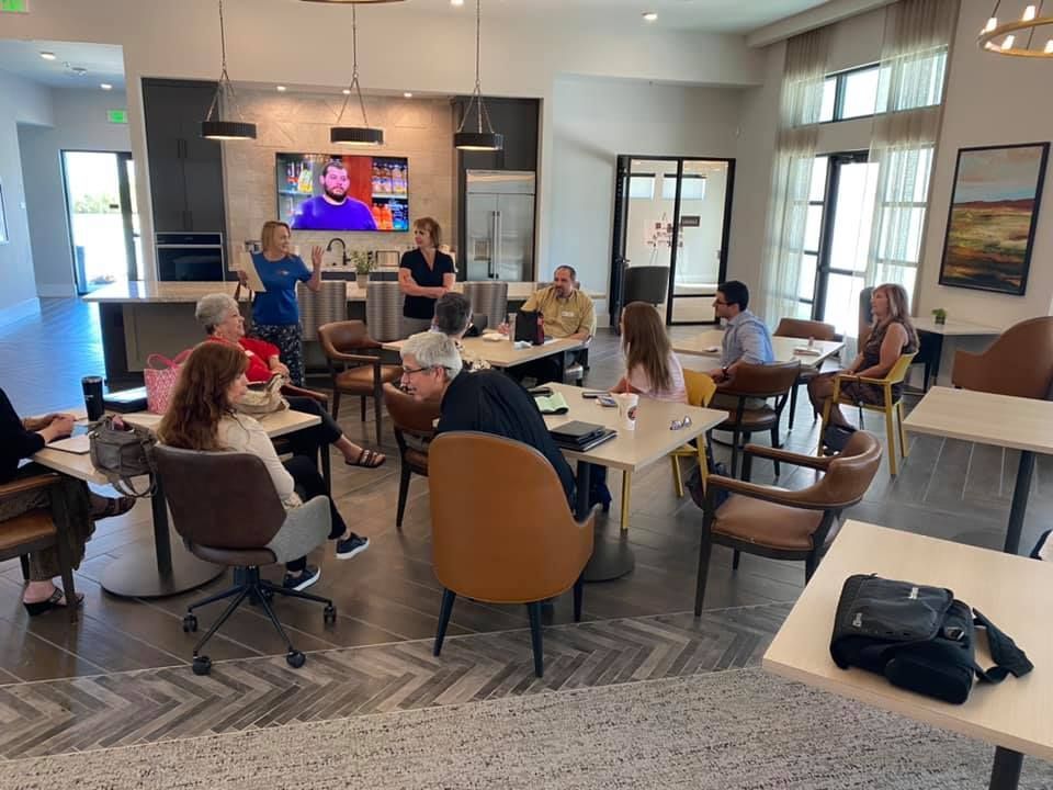 A group of people are sitting at tables in a room.