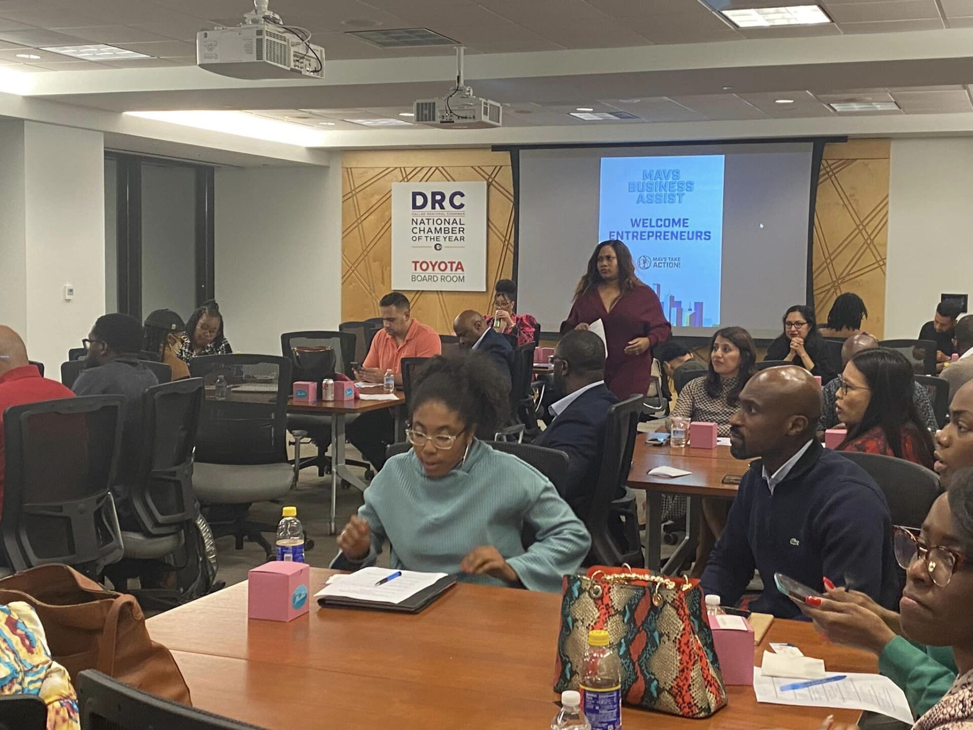 A group of people are sitting at tables in a room.