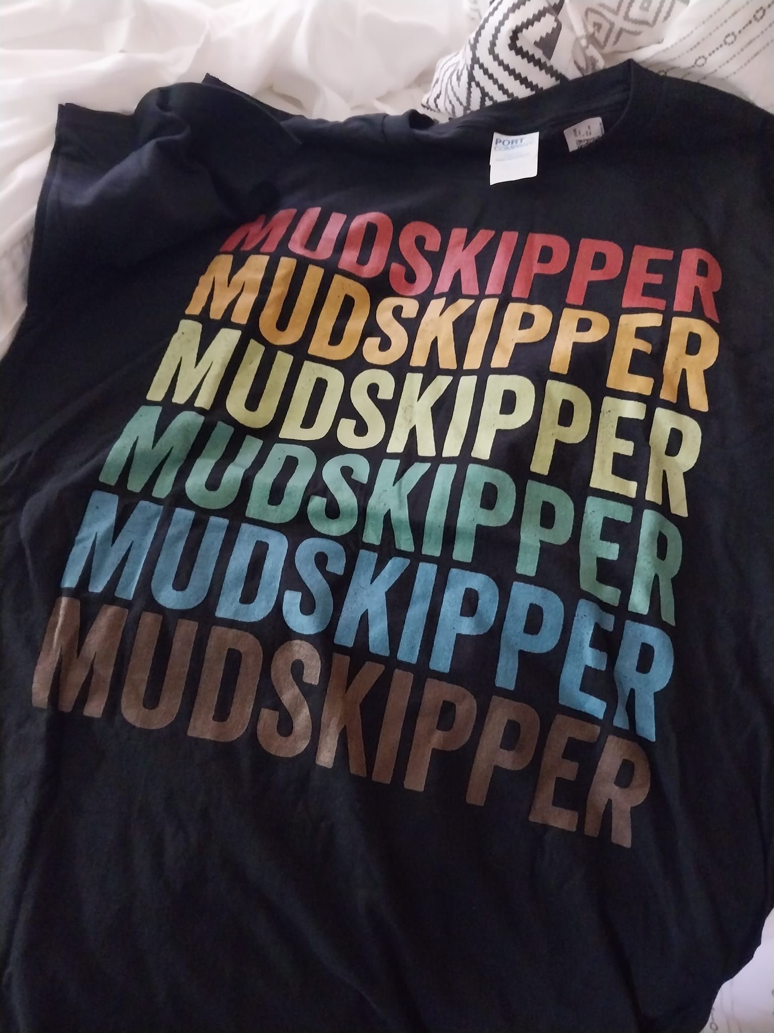 A black shirt that says mudskipper on it