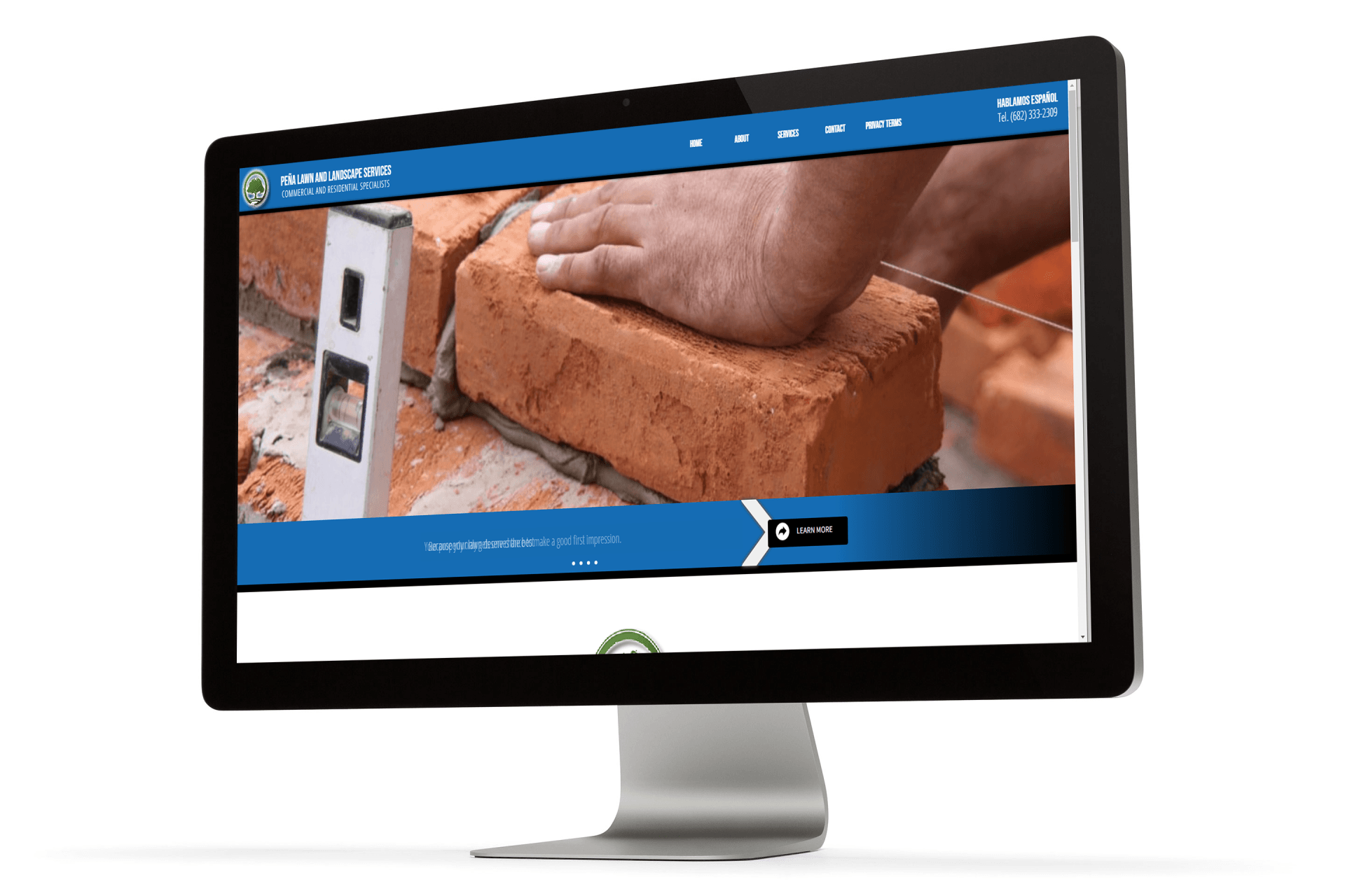 A computer monitor with a picture of a person laying bricks on it.