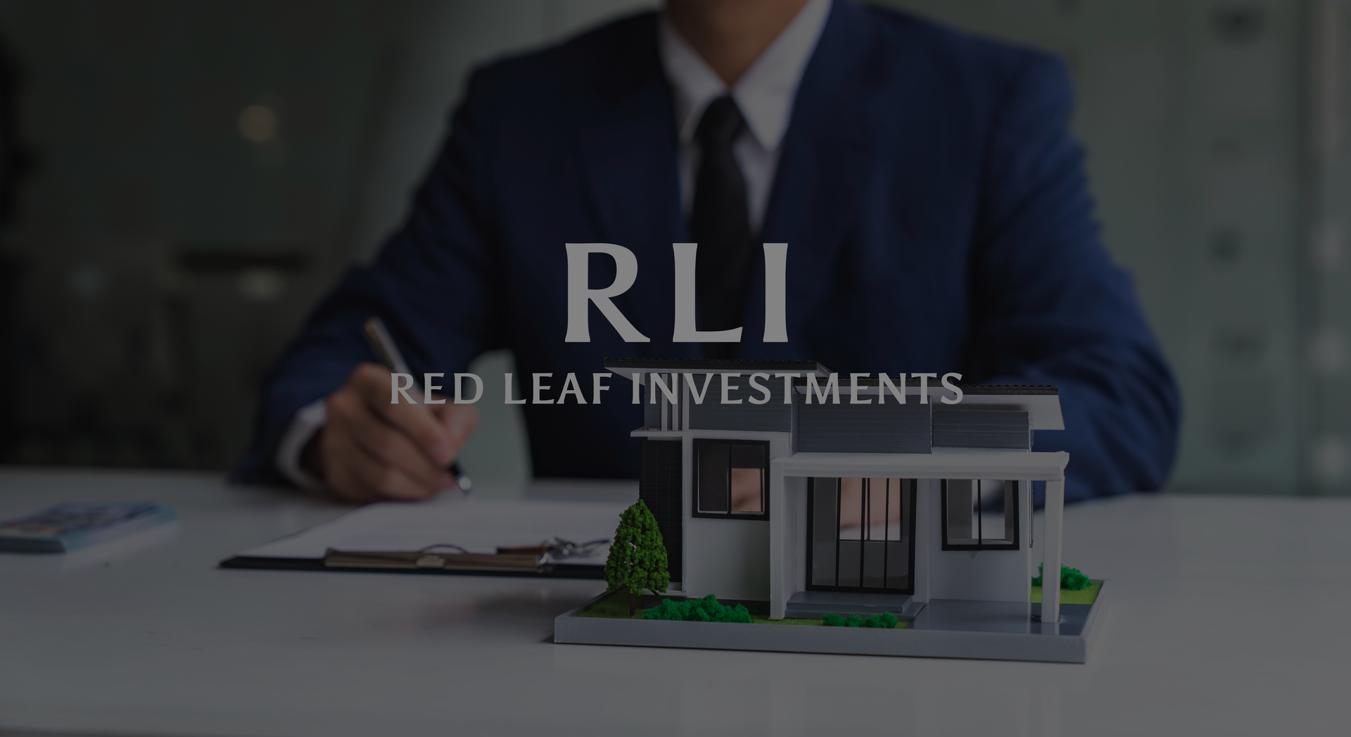 Image: Miniature bank building, gold coins, "RLI - Red Leaf Investments" text.