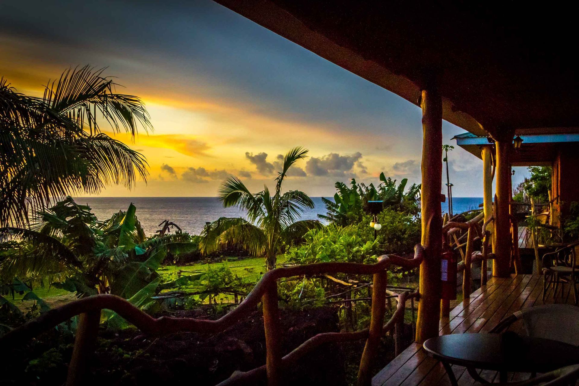 A view of the ocean from a balcony at sunset.