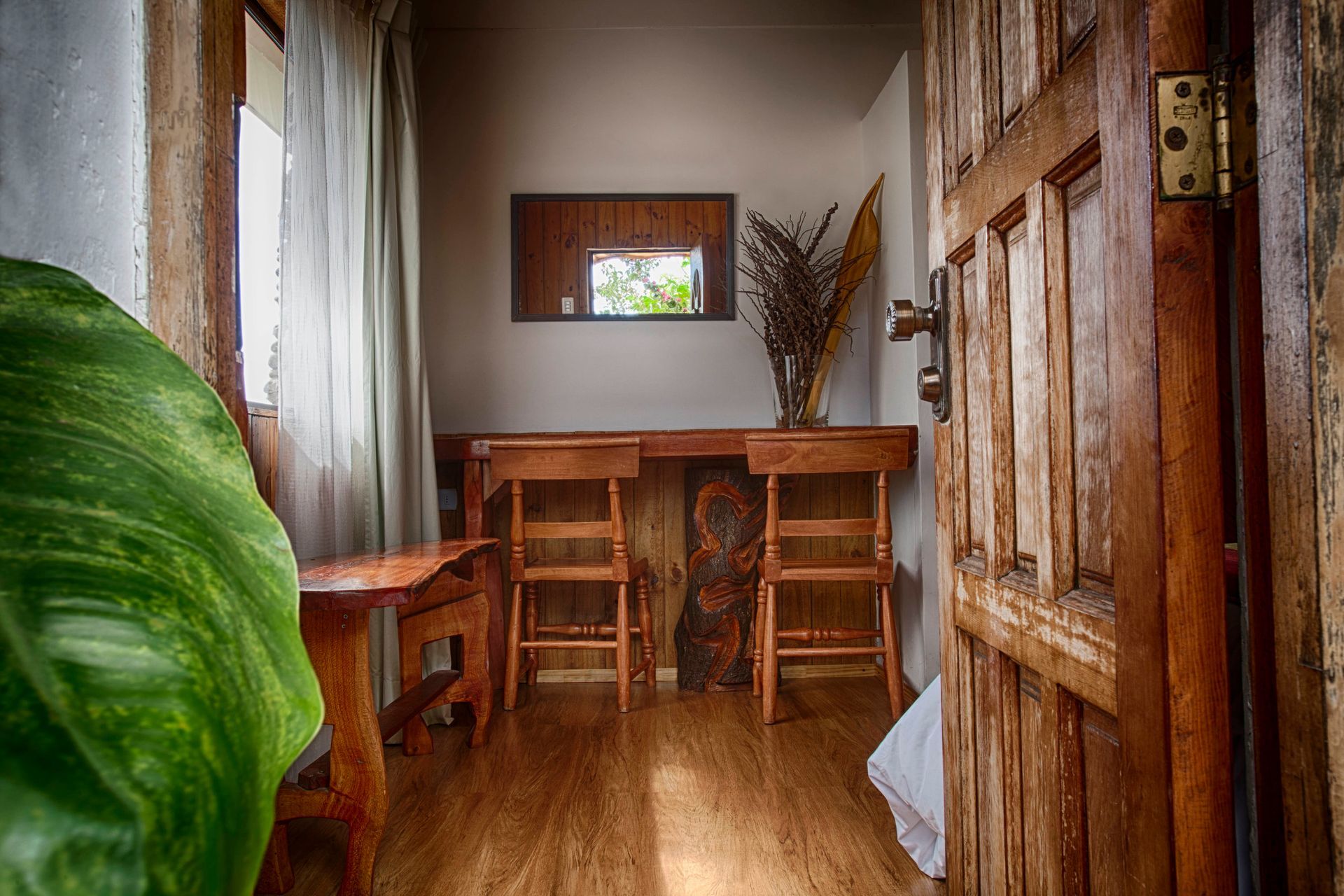 A woman in a hat is talking to two other women